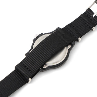 Black woven watch strap close-up with metal pins and side of round case back