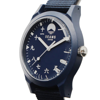 Close-up of navy dial wrist watch with numeric hour markers and BEAMS Japan text