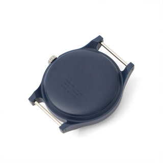 Navy round watch case back with metal crown posts on a fabric strap