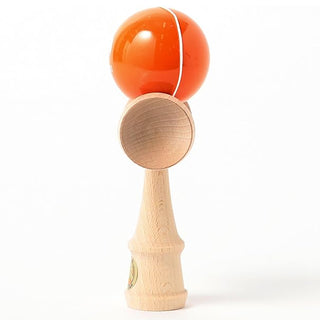 Wooden kendama with orange ball, two cups, and white cord on natural wood handle