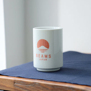 White sushi cup with red-orange BEAMS Japan logo on the front.