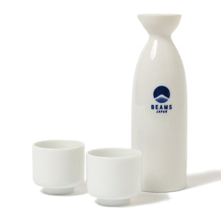 White ceramic sake bottle and two cups with BEAMS Japan logo, glazed finish
