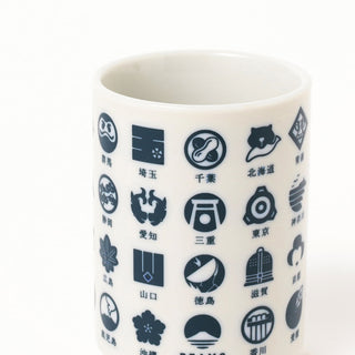 Indigo-blue map icon print ceramic sushi cup, close-up on white cylindrical body