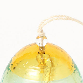 Gold glass bell wind chime with blue sides and beige hanging cord