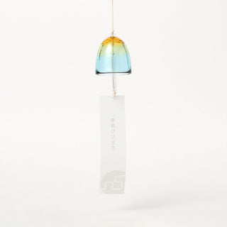 Golden and blue glass bell wind chime with long paper tag on hanging cord