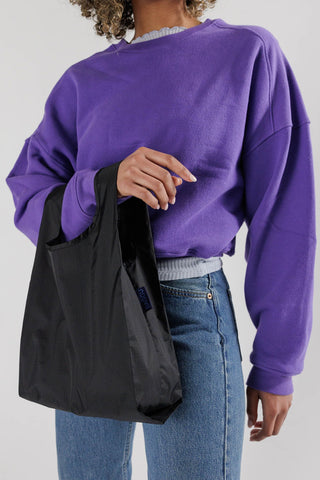 Black Baby BAGGU tote bag with side handles and blue logo tag