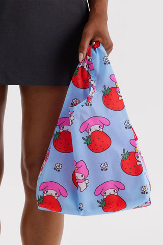 Light blue printed tote bag with short handles, held by a person