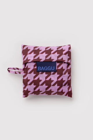 Baby BAGGU houndstooth pouch, pink with dark plum pattern and BAGGU logo