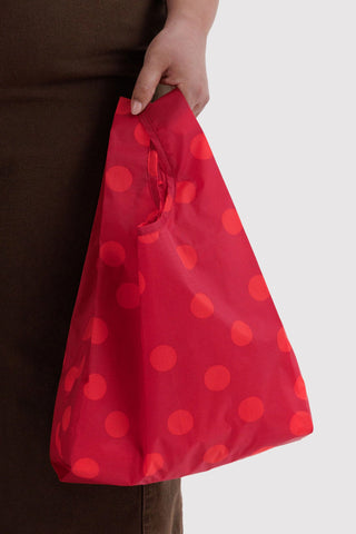 Baby BAGGU red polka-dot reusable bag, held open with wide tote shape