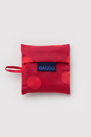 Baby BAGGU red polka-dot packable tote with blue BAGGU logo patch