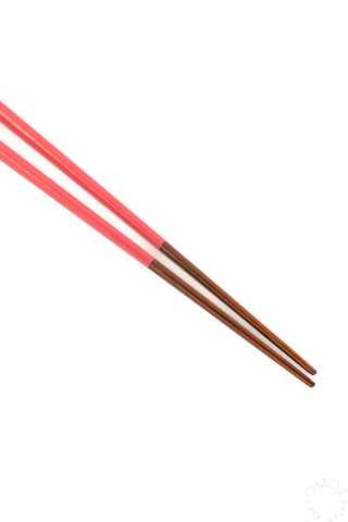 Red bamboo chopsticks with dark brown tapered tips, set of two.
