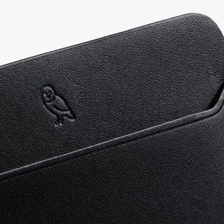 Bellroy black leather card slip with embossed logo and textured grain detail