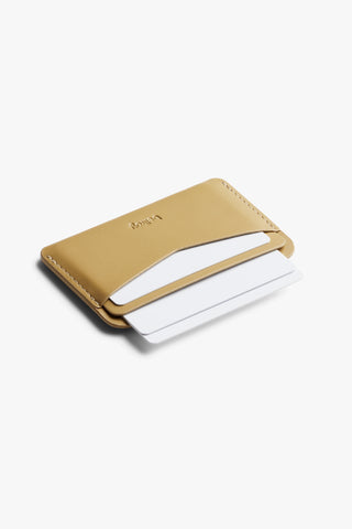 Mustard card slip wallet shown at an angle with open card slot, Bellroy logo.