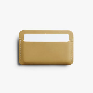 Mustard card slip wallet with open top slot and stitched border, Bellroy.