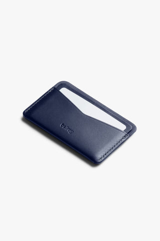Navy leather card slip with open card pocket and Bellroy logo