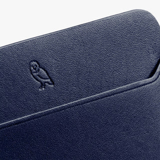 Navy leather card slip corner with embossed Bellroy logo