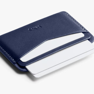 Navy leather card slip with cards partially inserted and stitched opening