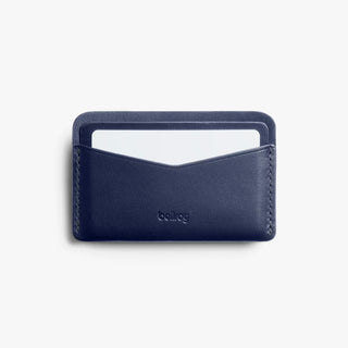 Navy leather card slip with open top card sleeve and embossed logo