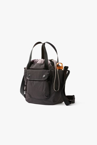 Charcoal cinch bucket bag with top drawstring, dual handles, and side zip pocket