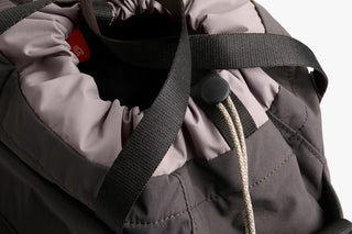 Close-up of charcoal bag interior and adjustable strap with textured webbing