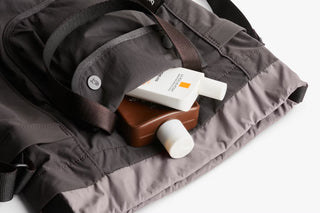Close-up of charcoal bag interior pocket holding cards and small accessories