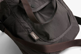 Charcoal bucket bag front panel with strap attachment and small logo patch