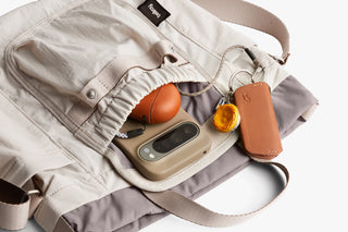 Oat bucket bag interior showing phone pocket and small leather pouches under drawstring
