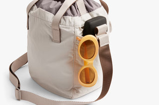 Oat bucket bag with sunglasses holder detail and top loop handles