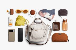 Oat cinch bucket bag with multiple matching accessories shown around it