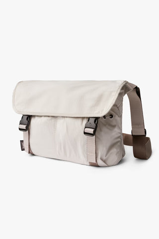 Oat light-beige crossbody messenger bag with front flap and side strap hardware