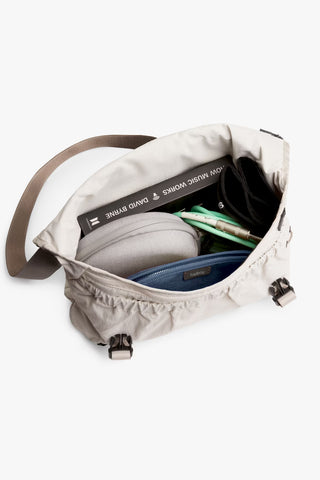 Oat light-beige messenger bag interior with open top and zippered pocket