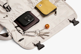 Oat light-beige messenger bag interior with phone case, keys, and accessory pockets