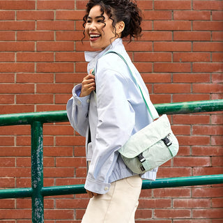 Lilac mini messenger bag worn crossbody with adjustable strap