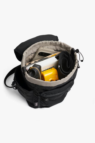 Black mini backpack open top with light lining and drawcord, holds everyday essentials