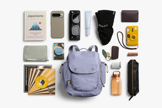 Lilac mini backpack laid flat, showing compact storage with accessories inside