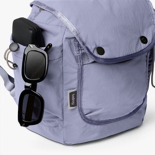 Lilac mini backpack front view with button accents and attached glasses case