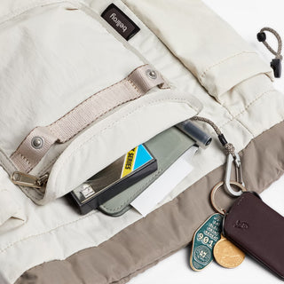 Bellroy cinch minipack backpack, oat; zip pocket holding small cards and key clip