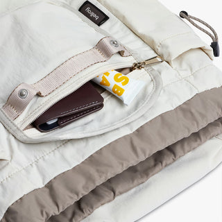 Bellroy cinch minipack backpack, oat; open front pocket with elastic divider and zipper