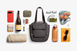 Bellroy cinch tote bag with accessories laid out on a flat surface