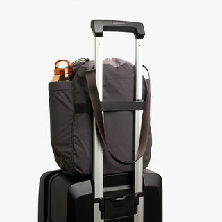 Bellroy cinch tote bag on telescoping carry handle, charcoal fabric exterior