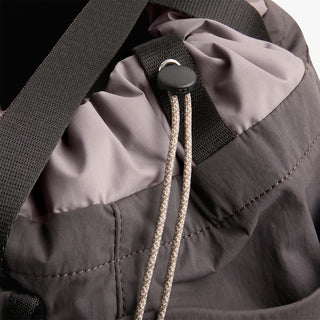 Bellroy cinch tote close-up of drawstring cord and metal grommet on charcoal fabric