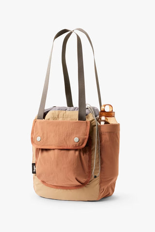 Tan cinch tote bag with front flap pocket and two top carry handles