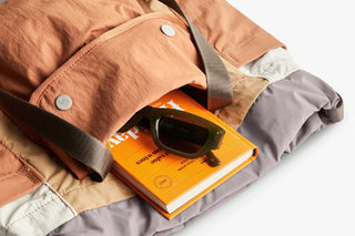 Tan cinch tote close-up with snap-button pocket and fabric interior panel