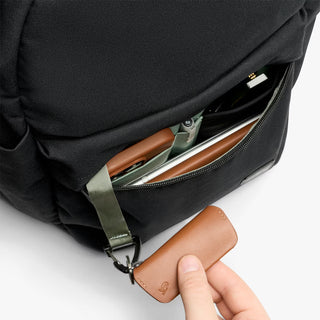 Black backpack front pocket open with card slot and zip organizer, brown leather pull