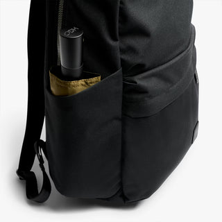 Black side pocket with zipper holding a bottle, with stitched side panel
