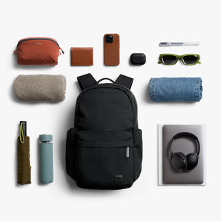 Black daypack centered with front zip pocket and padded shoulder straps