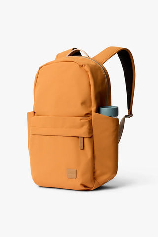 Orange daypack with front zip pocket, padded back, and top carry handle.