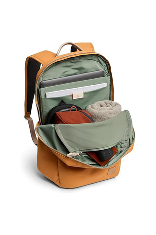 Orange daypack open view showing green-lined interior pockets and a zipper divider.