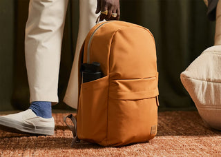 Bellroy Classic Daypack in tan, side view with front pocket and top handle