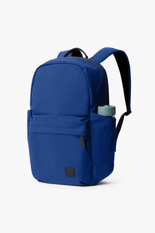 Bellroy Classic Daypack in indigo blue with front pocket and black top handle trim